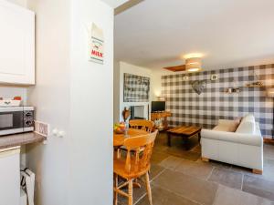 a kitchen and living room with a table and a couch at Ivy Cottage in Ripon