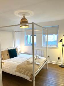 a bedroom with a bed with a metal canopy at Bellevue Apartment in Largs