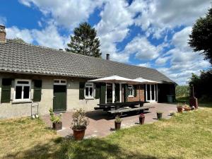 a house with a picnic table in front of it at Spacious Farmhouse near Forest in Stramproy in De Horst