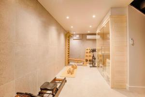 a hallway of a house with a gym at Villa Stella - Sauna Jacuzzi - Deauville Centre in Deauville