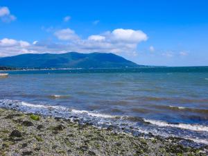 a body of water with mountains in the background at Lough Álainn - Tourism NI Certified in Warrenpoint