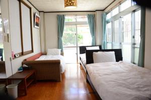 מיטה או מיטות בחדר ב-Accommodation Limited to One Group Per Day Yukuiru