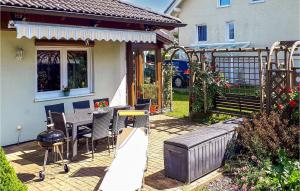 a patio of a house with a table and chairs at Beautiful Home In Brnlos With Wifi 