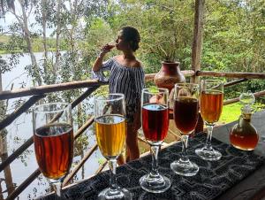 a woman standing next to a table with wine glasses at Casa Kukama Lodge in Iquitos