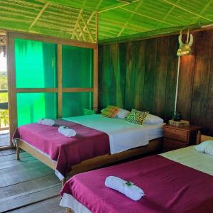 Tempat tidur dalam kamar di Casa Kukama Lodge
