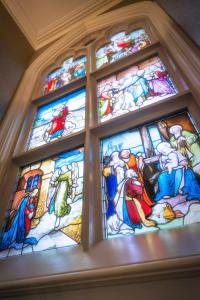 a group of stained glass windows in a church at Ascot House in Harrogate