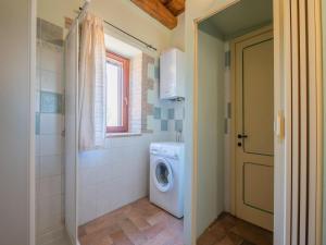 a bathroom with a washing machine and a washer at Holiday Home in Sellano with Pool & Sun Terrace in Sellano