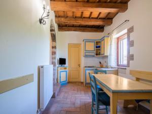 a kitchen with blue cabinets and a table in a kitchen at Holiday Home in Sellano with Pool & Sun Terrace in Sellano