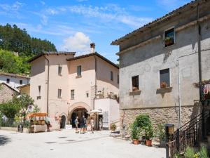 a group of people walking in front of a building at Holiday Home in Sellano with Pool & Sun Terrace in Sellano