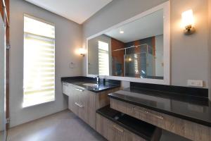 a bathroom with a sink and a mirror at One Hagdan Villas in Boracay
