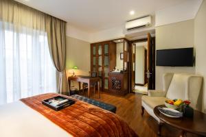 a hotel room with a bed and a desk at La Siesta Classic Ma May in Hanoi