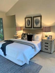 a bedroom with a large white bed and two lamps at Secluded Retreat in Noosa Hinterland in Eumundi