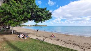 a group of people sitting on the beach at Auberge du MOCAMBO in Noumea