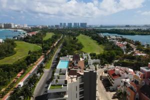 an aerial view of a city with a body of water at Beautiful room well located in the hotel zone of Cancun in Cancún