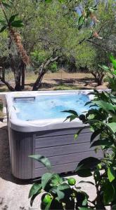 a hot tub in the middle of a yard with trees at Liostasi Maison Provencale in Argostoli
