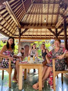 a group of women sitting at a table at Wina Ubud B&B in Ubud