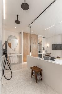 a white bathroom with a sink and a mirror at Galini Hotel in Naxos Chora