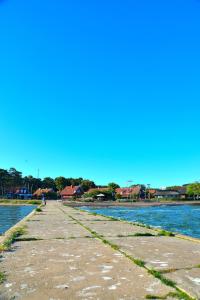 a pathway next to a body of water at Vila Kopa Nida in Nida