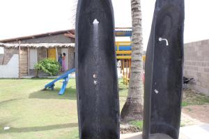 a playground with a slide and a tree at Pousada Solar das Flores in Conceição da Barra