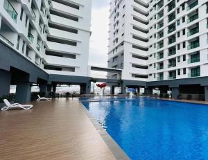 a swimming pool in a building with two tall buildings at D'A4 Homestay @ Vista Bangi in Kajang