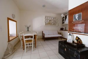 a kitchen and living room with a table and chairs at Villa Luce in Halki