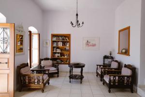 a living room with chairs and a table and a mirror at Villa Luce in Halki
