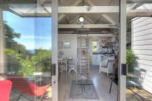 a living room and kitchen with a view of a house at Little West Hill Studio in Lyme Regis