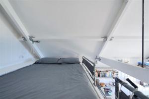 Cette chambre mansardée comprend un lit. dans l'établissement Little West Hill Studio, à Lyme Regis