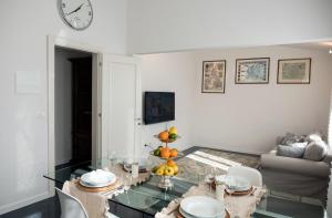 a living room with a table and a clock on the wall at Artemisia in Viareggio