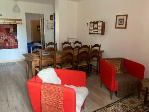a living room with a dining room table and chairs at Essentiel Barret in Barret-sur-Meouge
