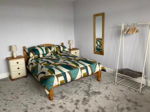 a bedroom with a bed and a mirror at Contemporary living with amazing views. Pembrokeshire in Pembrokeshire