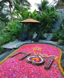a flower carpet of flowers in the shape of a number at Mandana Ubud Villa in Ubud