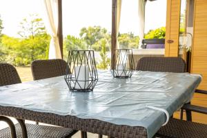 a table with three candle holders on top of it at SunnySide nyaraló in Szarvas