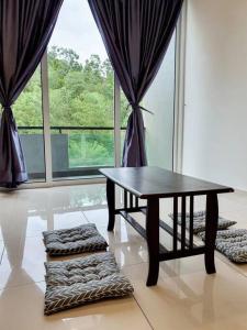a table in a room with a large window at Villa near Bukit Indah / Eco Botanic / Legoland / Horizon Hill in Gelang Patah