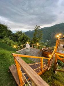 a deck with a picnic table on top of a mountain at Pano Blueberry in Namlisevi +8 photos