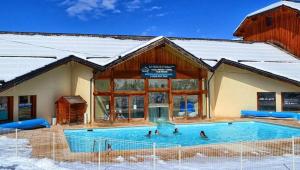 un grupo de personas en una piscina en la nieve en Superbe appartement aux Orres 1800, six couchages, en Les Orres