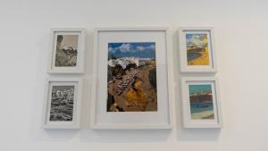 a white frame with three pictures on a wall at In Downtown - Villa Serenity in Albufeira +39 photos