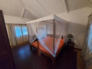 a bedroom with a bed with a canopy at La Bella Donna in Ifaty