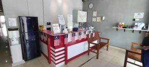 a red and white counter in a room with a refrigerator at Best Hotel Shah Alam @ UITM, i-City & Hospital in Shah Alam