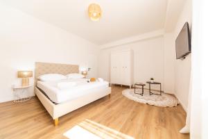 Posteľ alebo postele v izbe v ubytovaní Central Seaside Residence