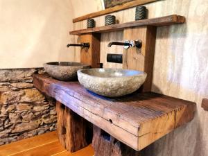 a bathroom with two sinks on a wooden counter at Mratschnigger Hof in Keutschach am See