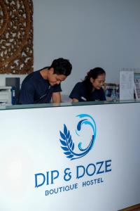 a sign for a dip and dye boutique hospital at Dip & Doze Boutique Hostel in Canggu