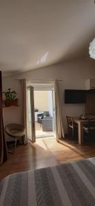 a bedroom with a bed and a sliding glass door at Apartments ALTO in Rovinj