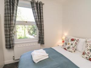 a bedroom with a bed and a window at Woodend in Saltburn-by-the-Sea