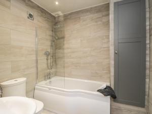 a bathroom with a tub and a toilet and a sink at Woodend in Saltburn-by-the-Sea +48 photos
