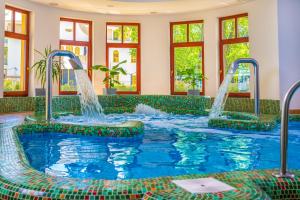 a pool with water jets in a hotel room at Hotel Anna Villa in Balatonföldvár