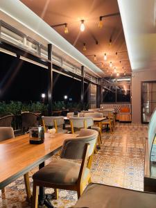 a restaurant with wooden tables and chairs and lights at PALMERA OLD CITY in Istanbul