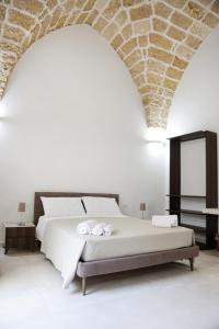 a bedroom with a bed with a stone ceiling at B&B LE DUE CORTI in Matino