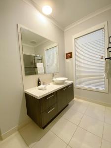 a bathroom with a sink and a mirror at DnF House in Williams Landing in Laverton
