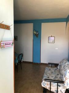 a room with a bed and a blue wall at La Terrazza sul Mare in Sellia Marina